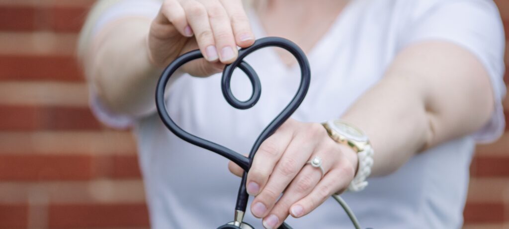 Nurse making heart with stethoscope