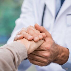 doctor holding patient's hand