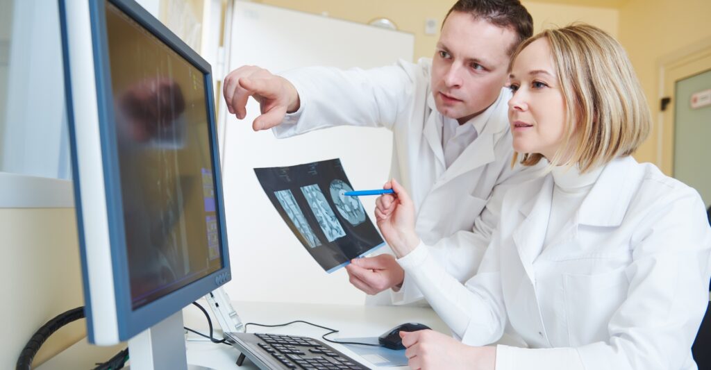 Co-workers analyzing MRI results