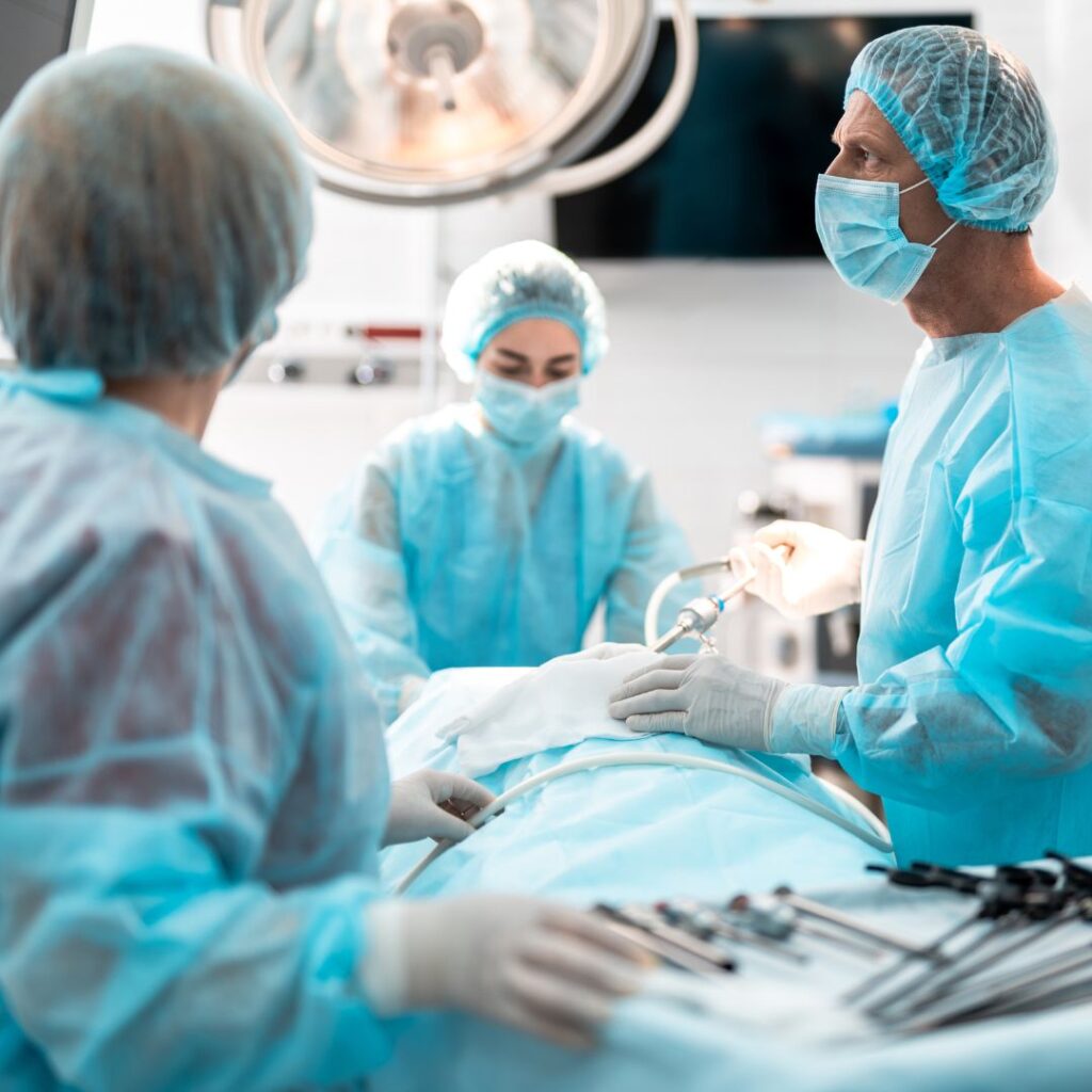 surgical tech reaching for surgical instruments