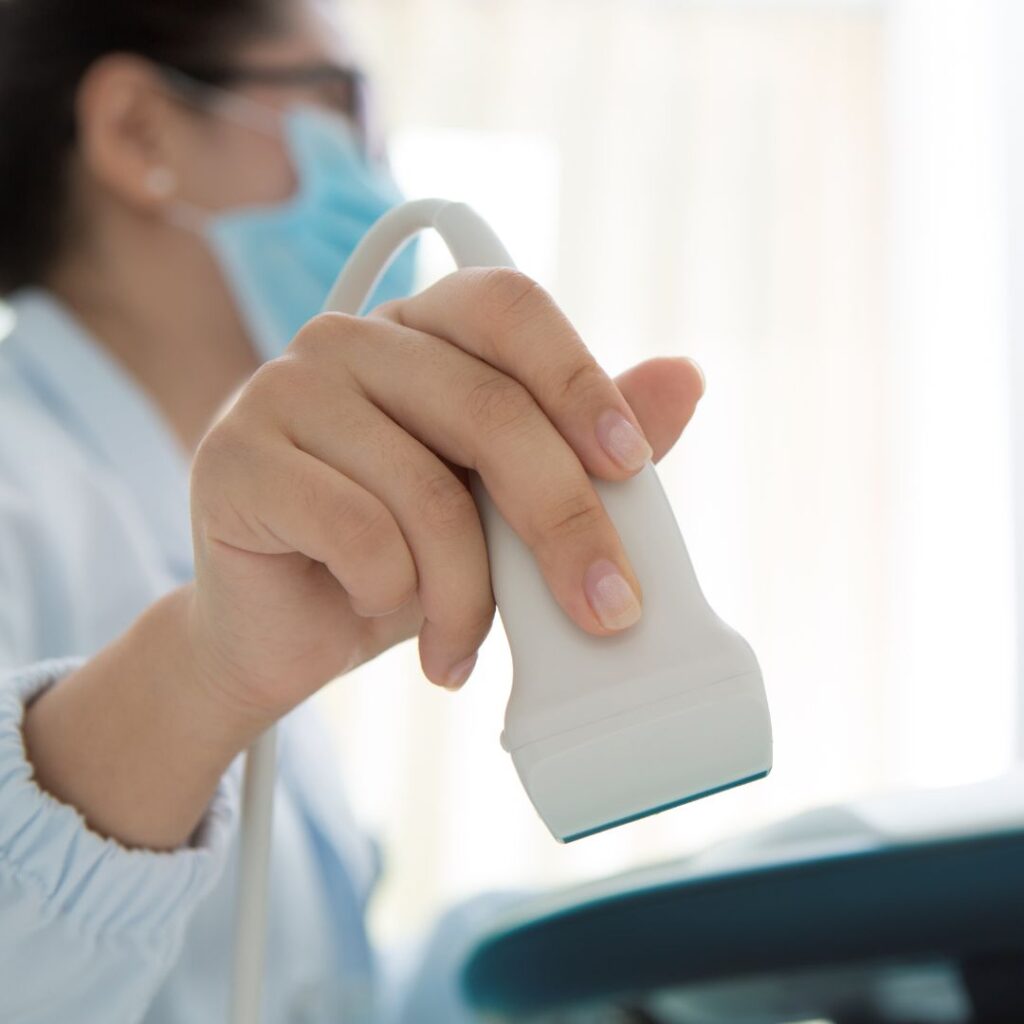 ultrasound tech using an ultrasound machine