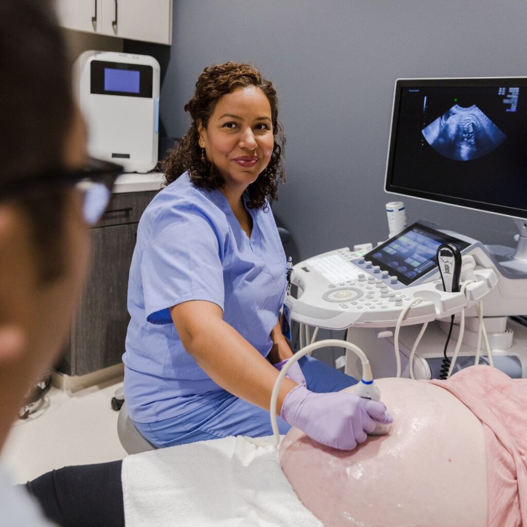 ultrasound tech checking a pregnant woman's stomach