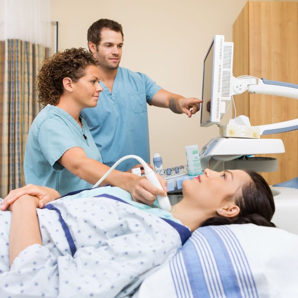 ultrasound tech checking a man's thyroid