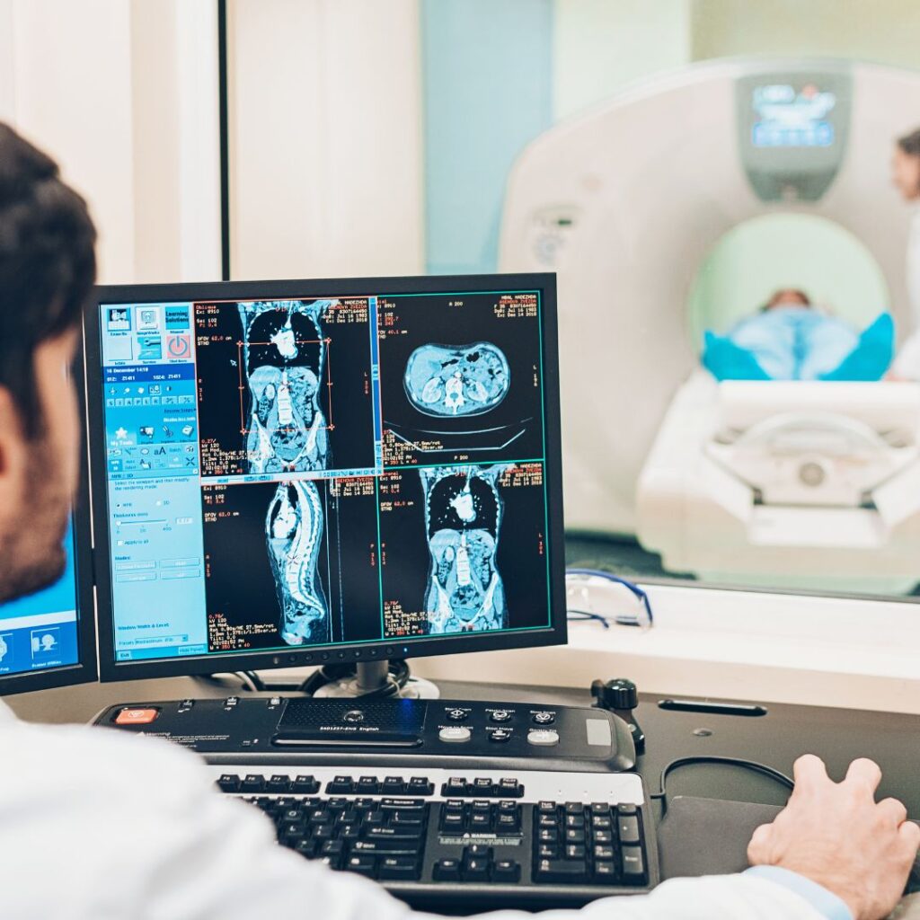 MRI technician looking at scan
