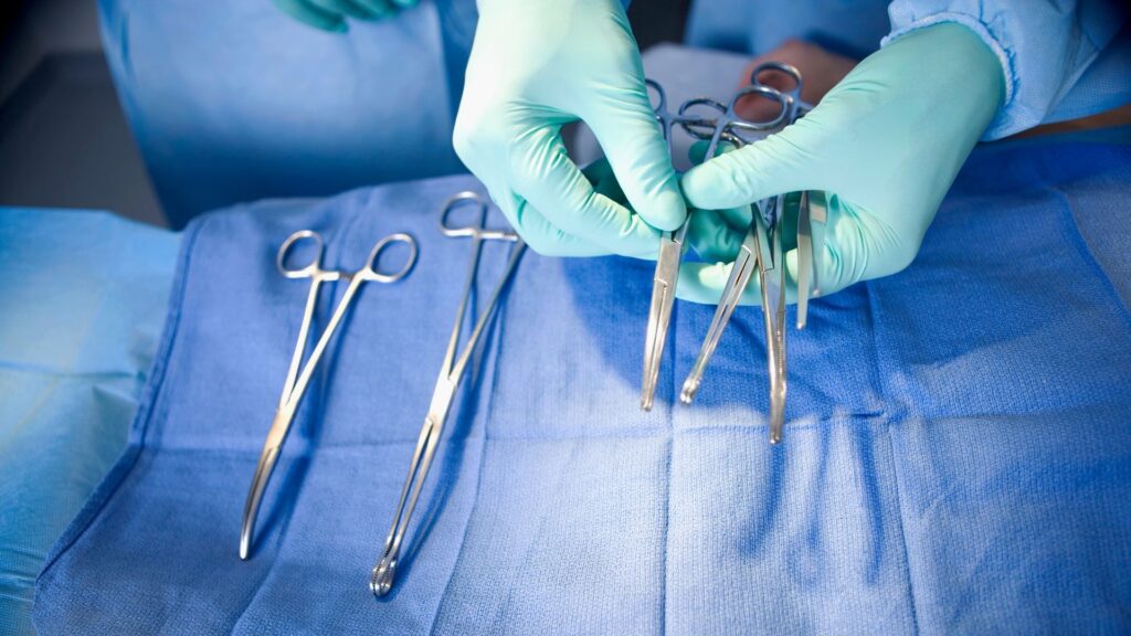 a person laying out surgeon tools