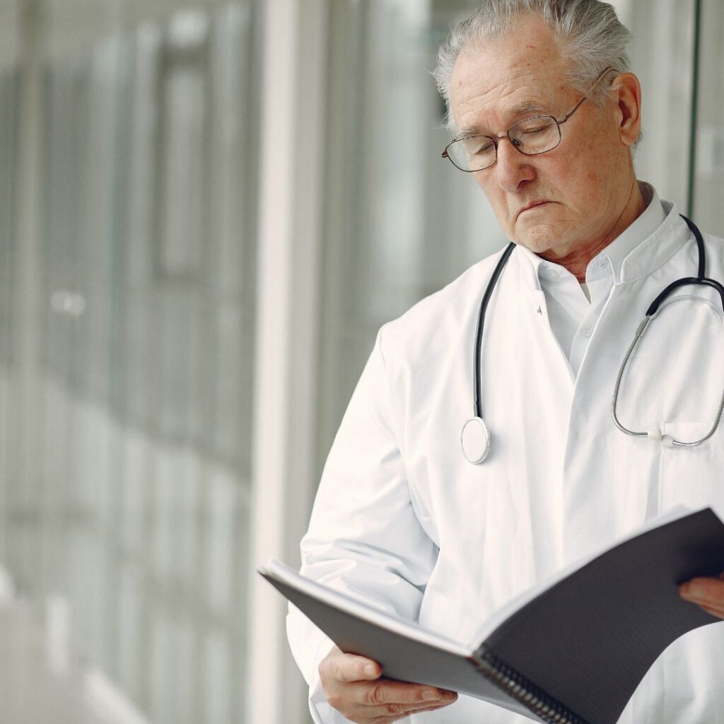 Doctor reading over notes in a hallway